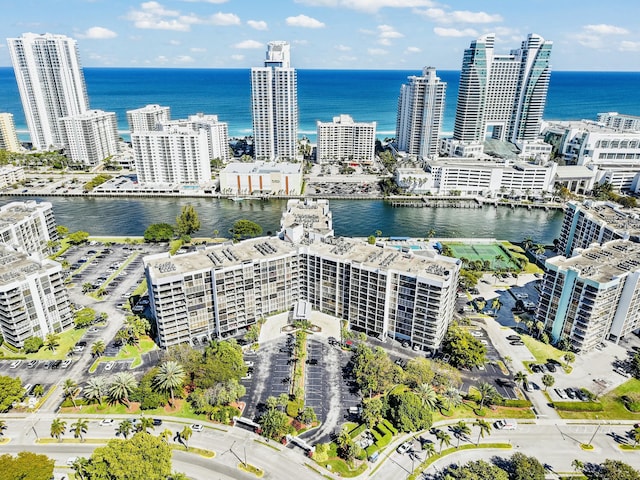 birds eye view of property with a view of city and a water view