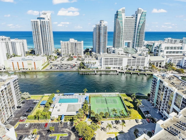 birds eye view of property featuring a city view and a water view