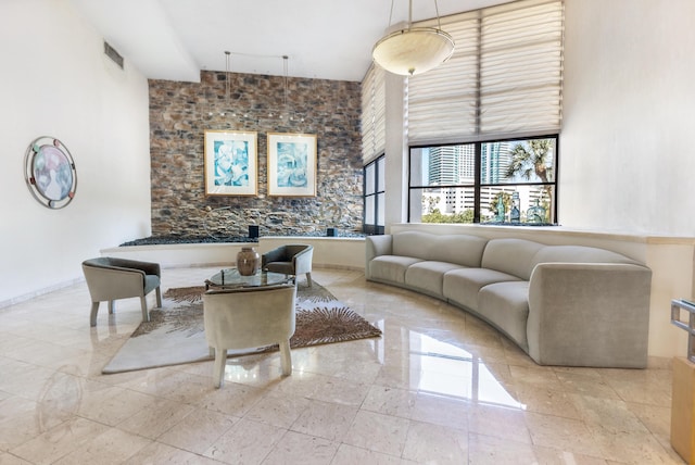 living area featuring baseboards and visible vents