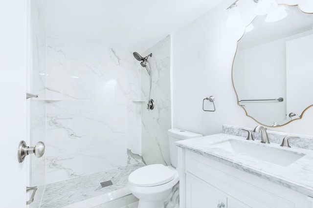 full bathroom with vanity, toilet, and a marble finish shower