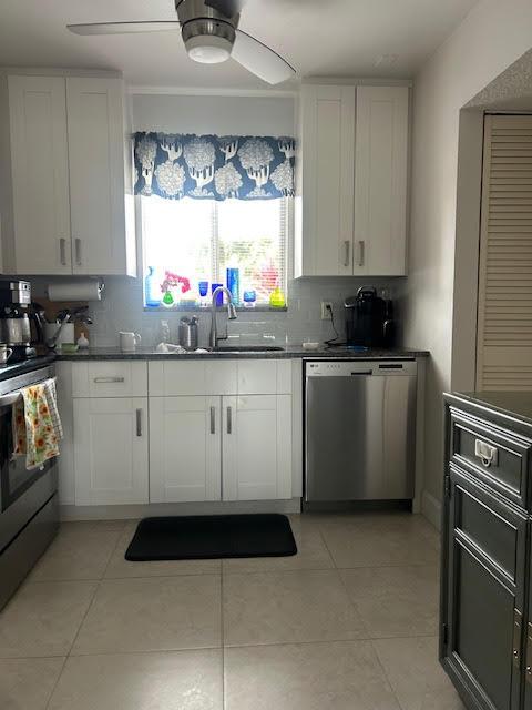 kitchen with stainless steel dishwasher, white cabinets, electric stove, and a ceiling fan