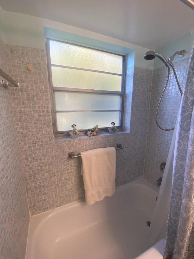 bathroom featuring plenty of natural light and shower / bath combo