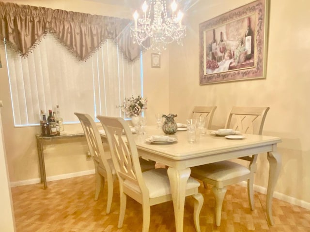 dining space with a chandelier and baseboards