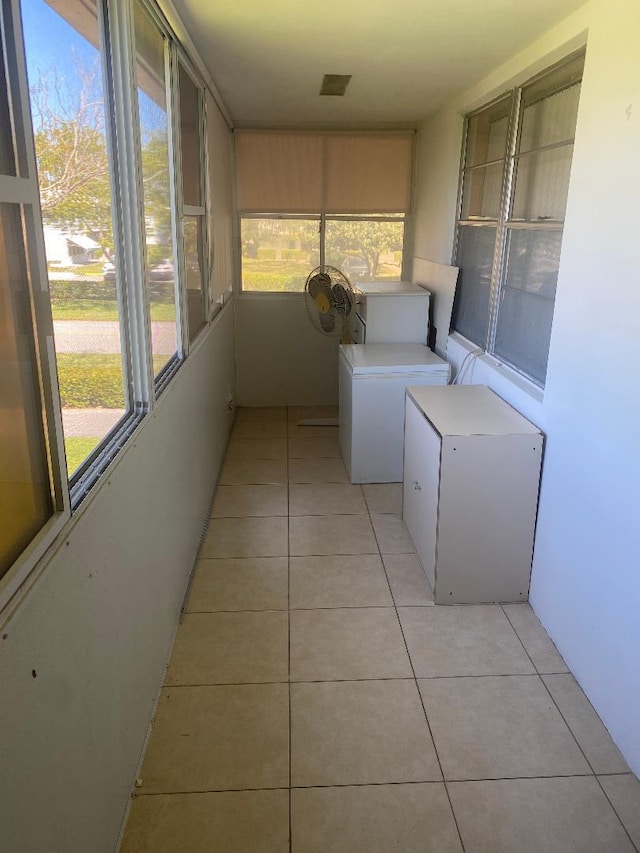 unfurnished sunroom featuring washer / clothes dryer