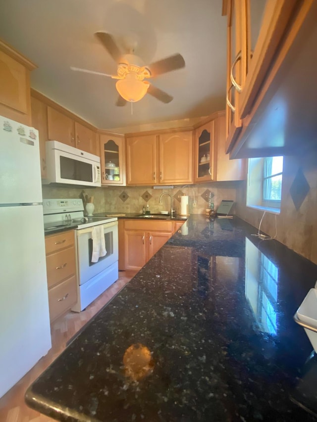 kitchen with backsplash, white appliances, glass insert cabinets, and a sink