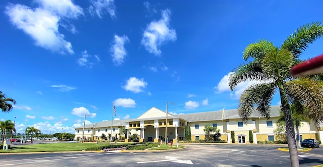 view of building exterior with uncovered parking