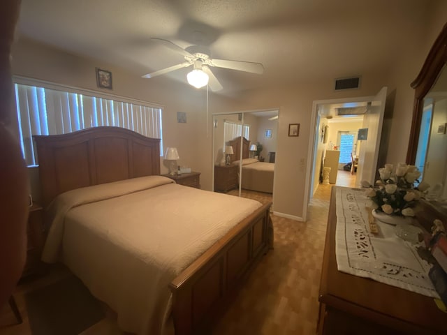 bedroom with a ceiling fan, visible vents, a closet, and baseboards