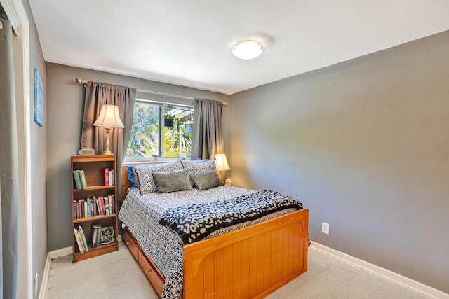 bedroom featuring baseboards and light carpet