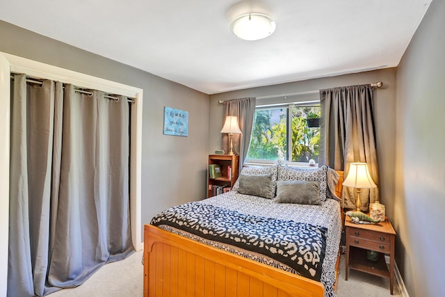 bedroom featuring light carpet