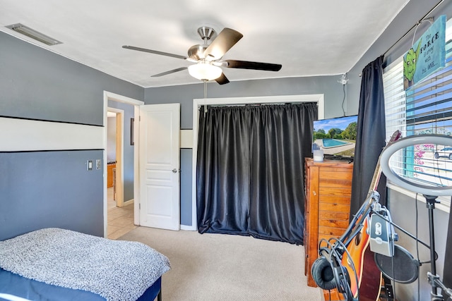 bedroom with visible vents, a ceiling fan, and carpet