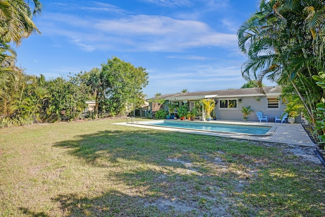 view of yard with an outdoor pool and a patio area