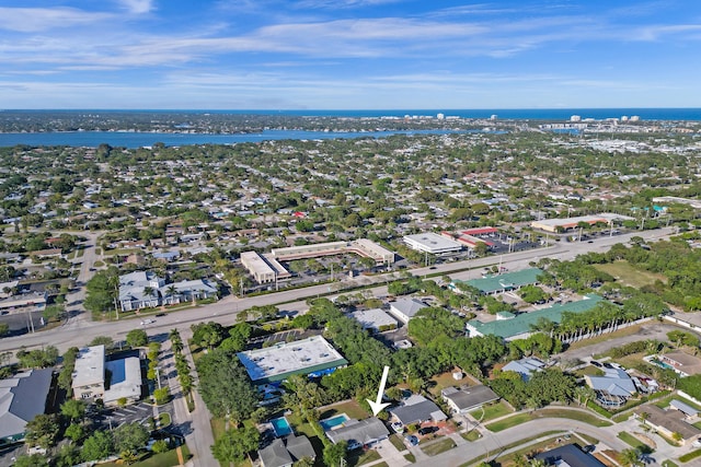 drone / aerial view featuring a water view and a residential view