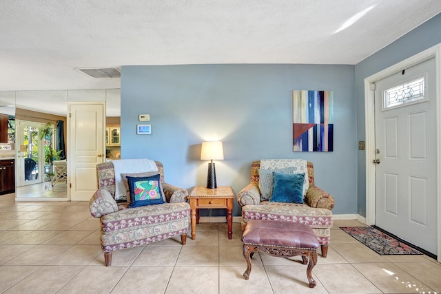 entryway featuring light tile patterned floors, visible vents, and plenty of natural light