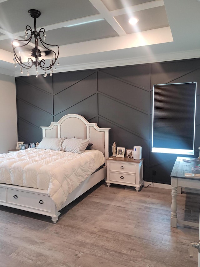 bedroom with a notable chandelier, wood finished floors, and coffered ceiling