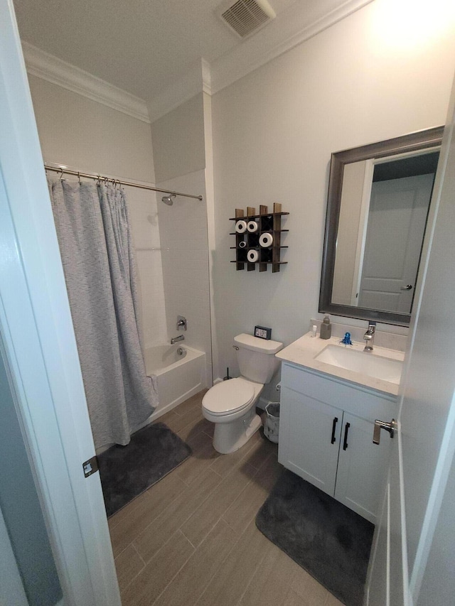 bathroom featuring vanity, visible vents, wood finish floors, crown molding, and toilet