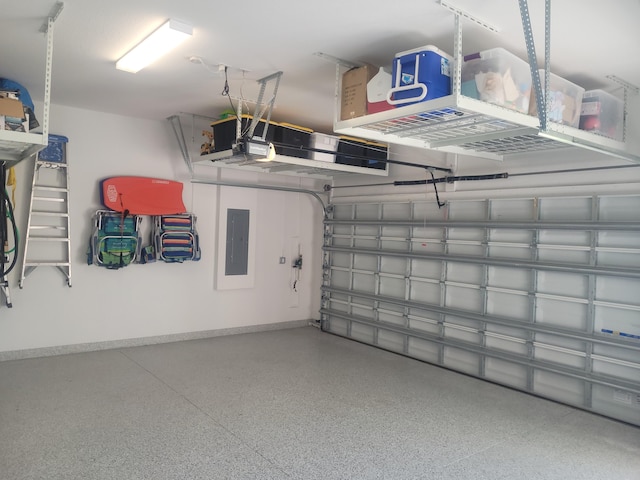 garage with electric panel and baseboards