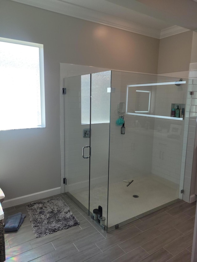 full bath with crown molding, baseboards, a stall shower, and wood tiled floor