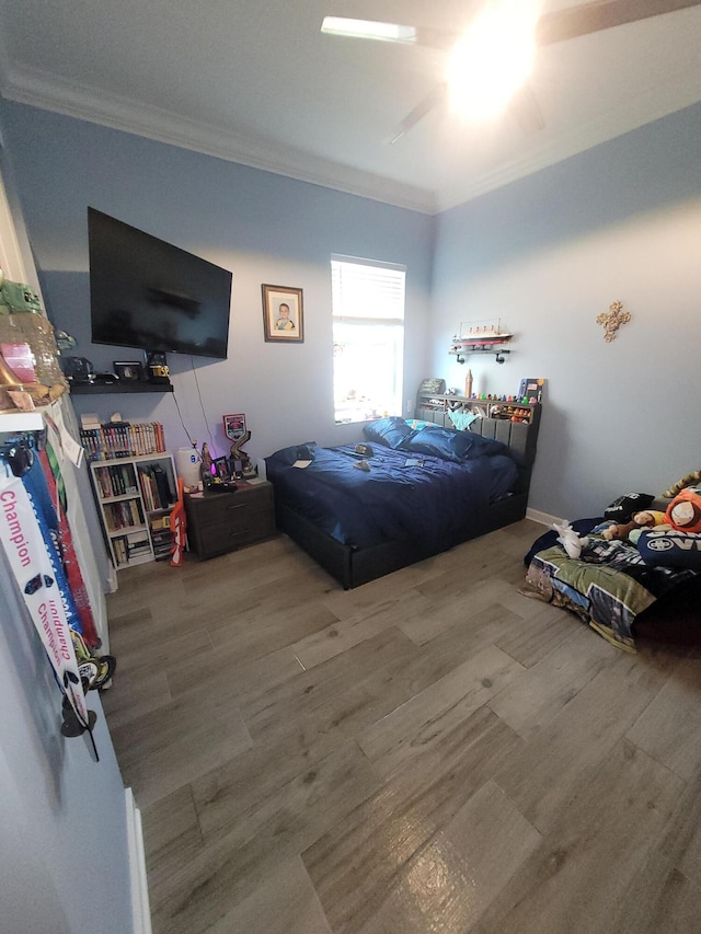 bedroom featuring crown molding and wood finished floors