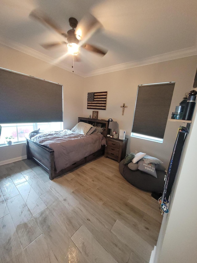 bedroom with light wood-style floors, a ceiling fan, and ornamental molding