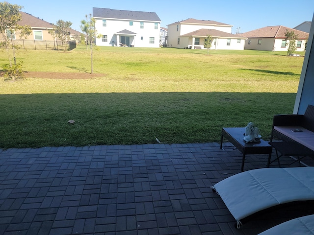 view of yard featuring a patio and a residential view