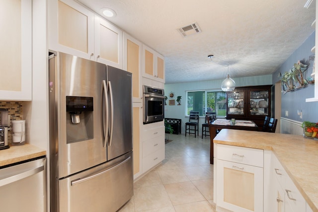 kitchen featuring visible vents, appliances with stainless steel finishes, white cabinetry, and light countertops