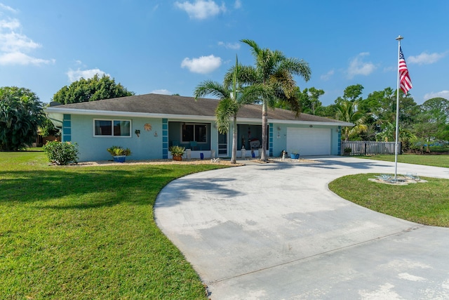 ranch-style home with stucco siding, driveway, fence, a front yard, and a garage