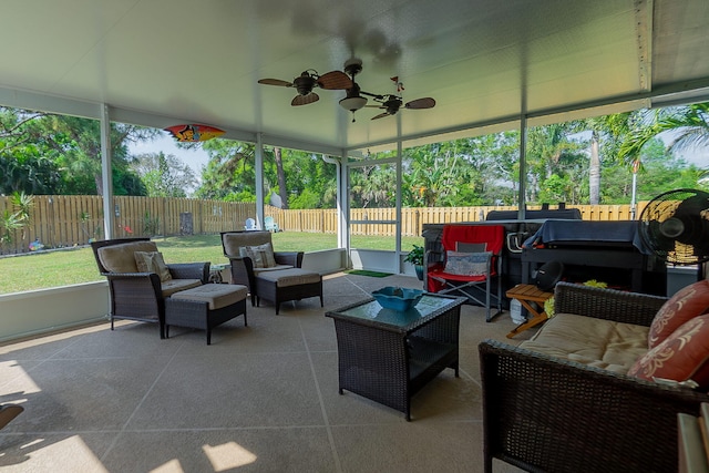 sunroom featuring a ceiling fan