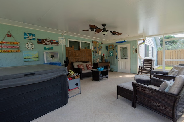 exterior space with an outdoor living space, fence, and ceiling fan