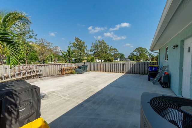 view of patio / terrace featuring area for grilling, central AC, and fence