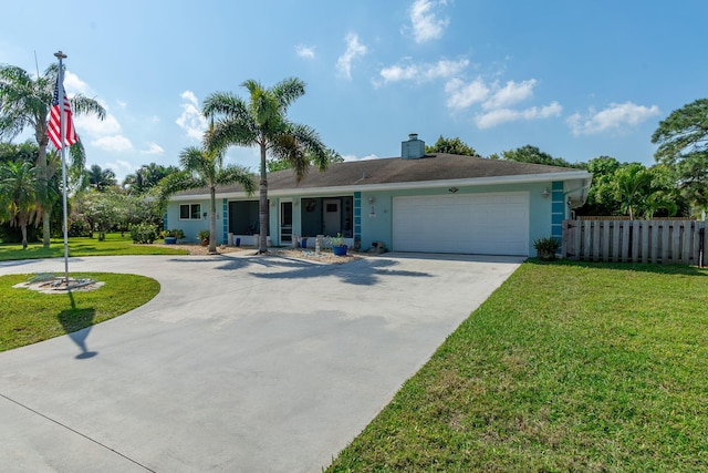 single story home featuring driveway, an attached garage, and a front yard