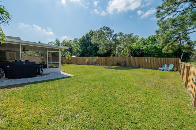 view of yard featuring a fenced backyard and a sunroom