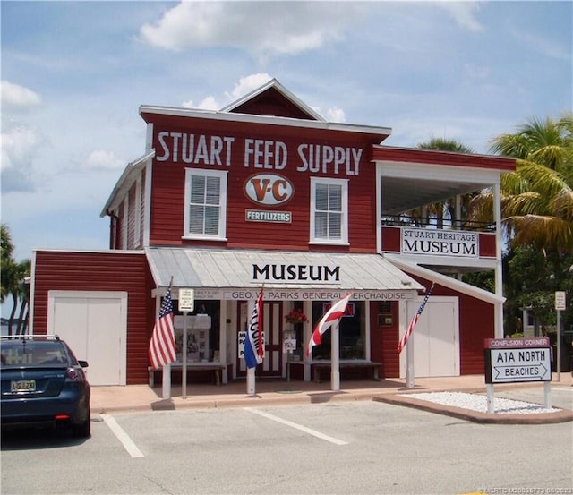 view of building exterior with uncovered parking