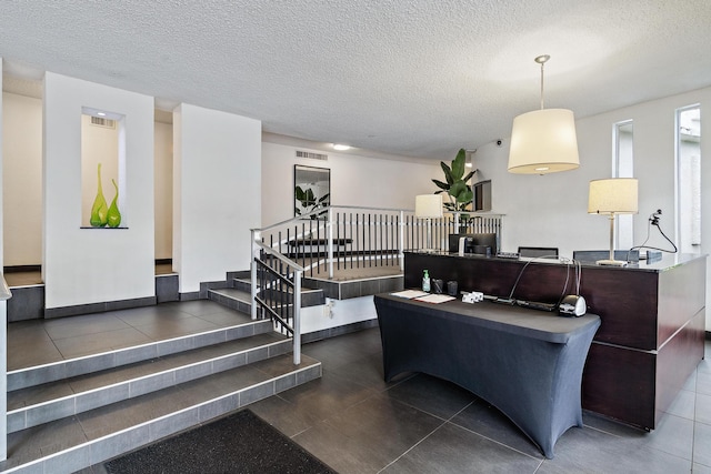 2760 S Ocean Blvd Unit 416, Palm Beach, FL 33480 - living area featuring tile patterned floors, stairs, and a textured ceiling