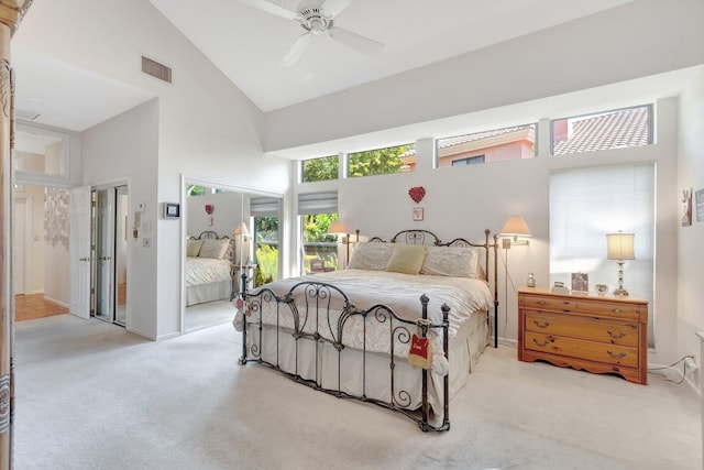 bedroom with light carpet, visible vents, high vaulted ceiling, and a ceiling fan