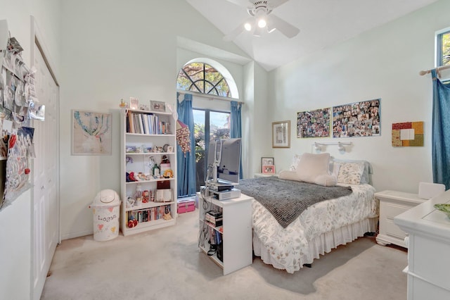 bedroom with carpet flooring, high vaulted ceiling, a ceiling fan, and access to outside