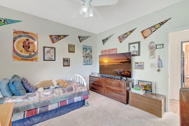 bedroom featuring light carpet and a ceiling fan