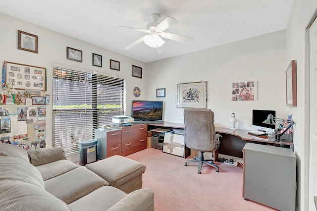 office featuring a textured ceiling, light colored carpet, and ceiling fan