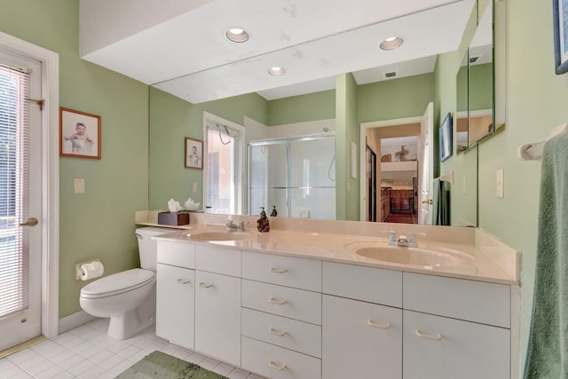 full bath with tile patterned flooring, a stall shower, toilet, and a sink