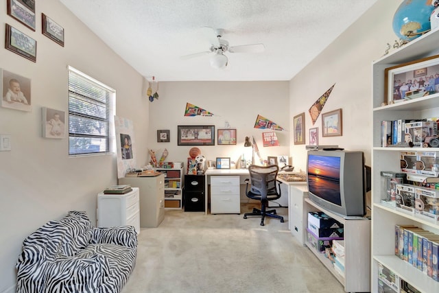 home office with light carpet, a textured ceiling, and ceiling fan