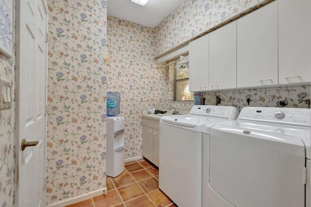 laundry area with wallpapered walls, baseboards, light tile patterned floors, washer and dryer, and cabinet space