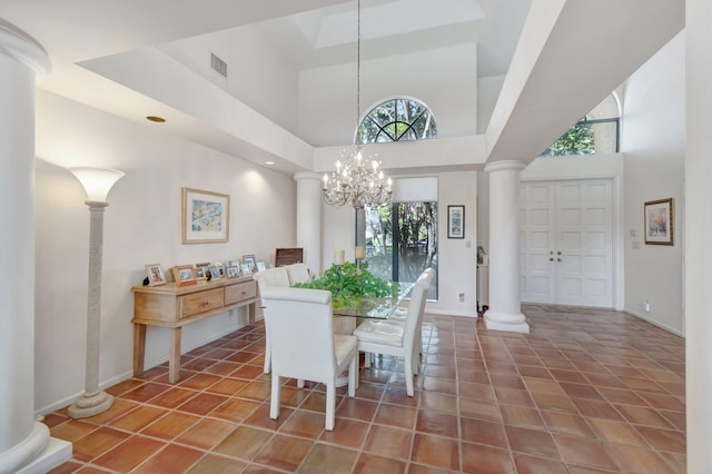 dining room with tile patterned floors, visible vents, a notable chandelier, and ornate columns