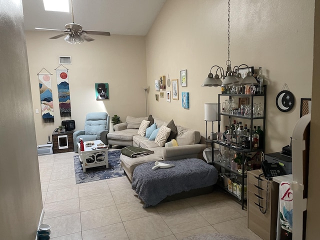 living area featuring light tile patterned floors, a ceiling fan, and visible vents