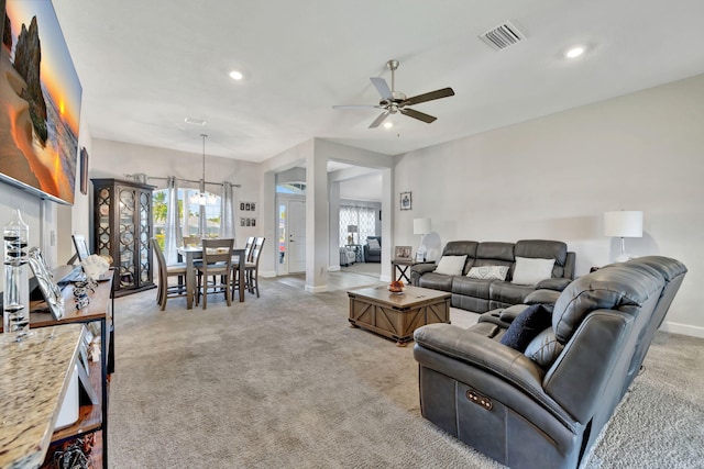 living area with baseboards, visible vents, recessed lighting, ceiling fan, and light carpet