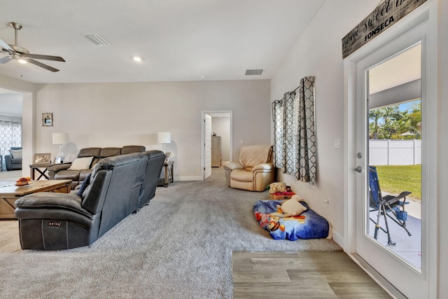 living area with visible vents, plenty of natural light, baseboards, and a ceiling fan