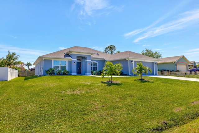 view of front of house featuring a front yard, fence, a garage, and driveway