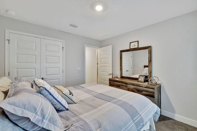 bedroom with carpet, visible vents, a closet, and baseboards