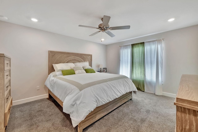 bedroom with baseboards, light colored carpet, and a ceiling fan