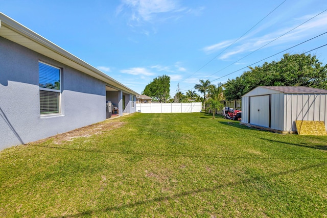 view of yard featuring a storage shed, an outdoor structure, and fence