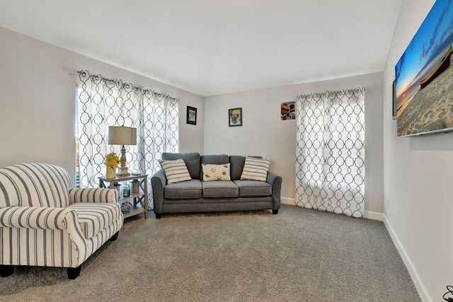 carpeted living area with baseboards