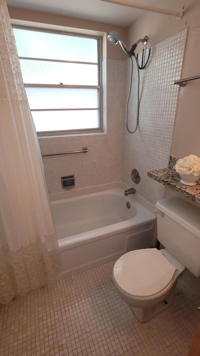 bathroom with toilet and shower / tub combo with curtain